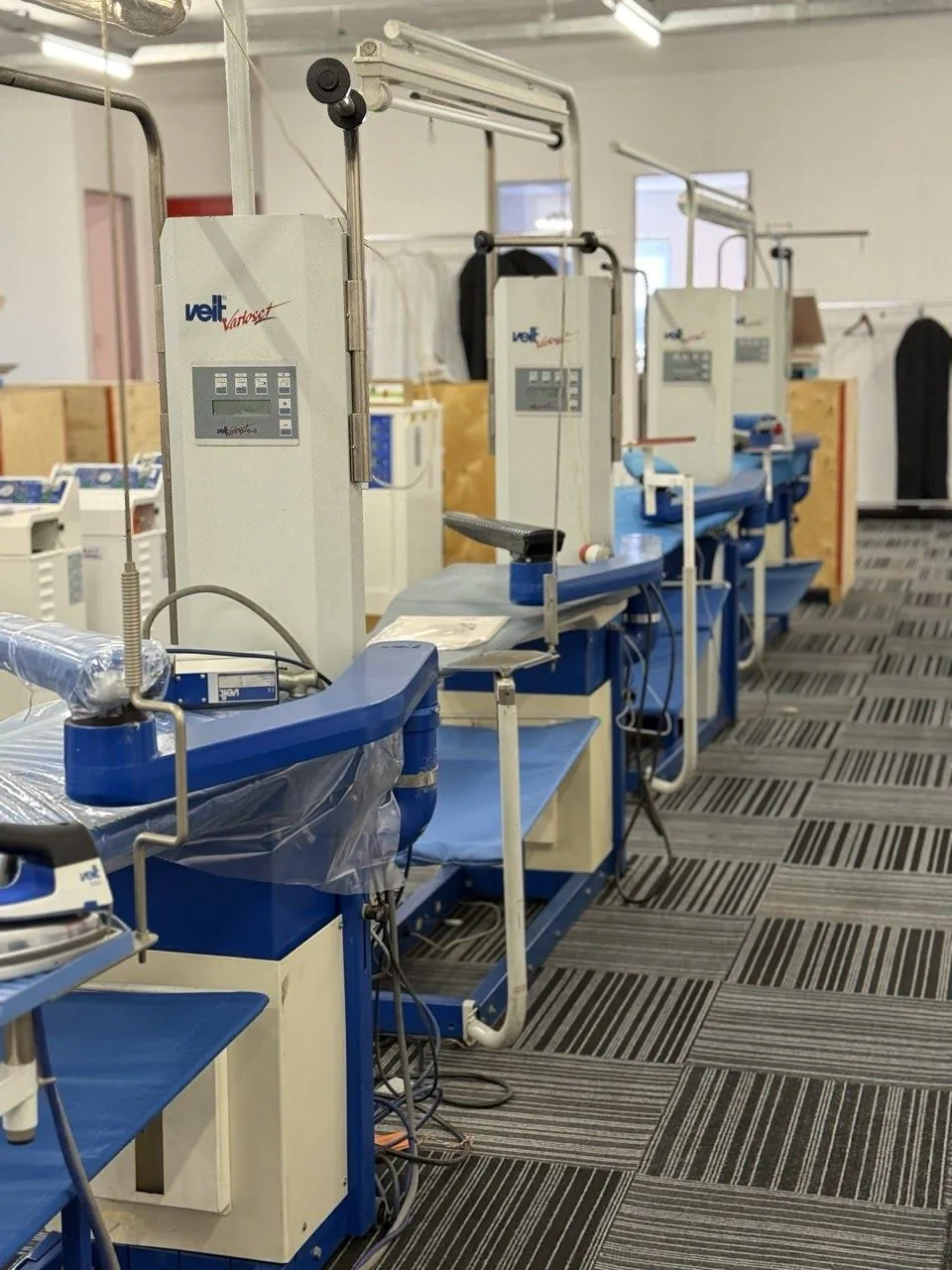 A row of VEIT finishing machines on the Universe Corp showroom floor